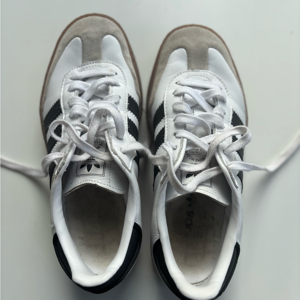 Adidas Sneakers. Classic white with black stripes. Elevated sole.